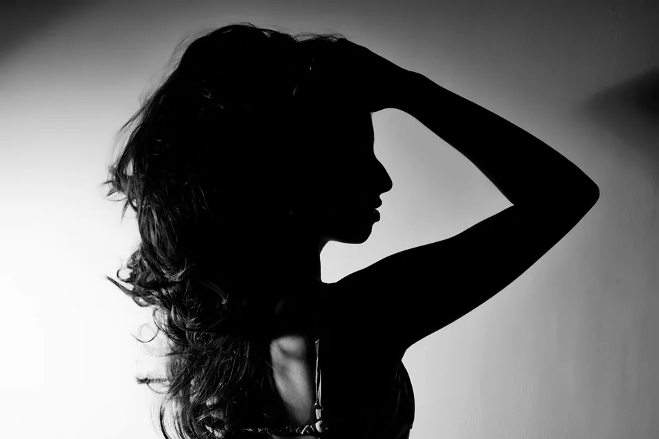Profile silhouette of Shrinkhla with a hand in her hair