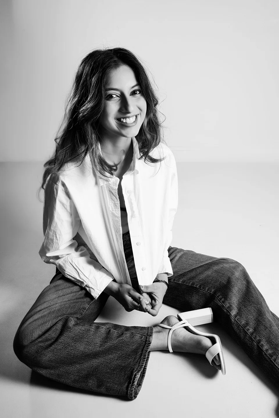 Smiling seated studio portrait of Shrinkhla in a white shirt